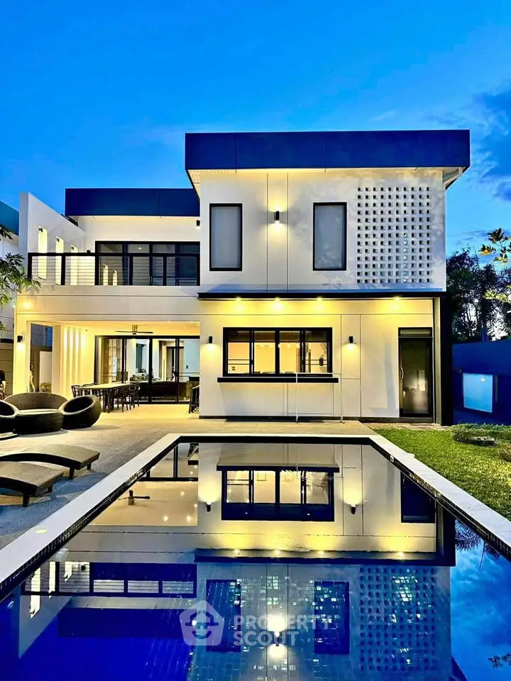 Stunning modern villa with pool and elegant exterior lighting at dusk.