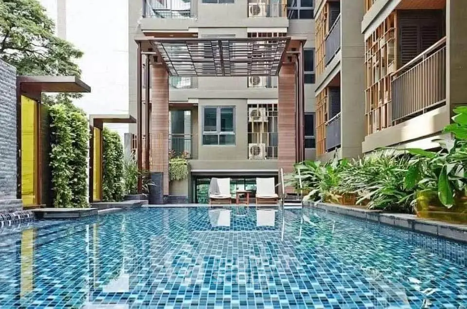 Luxurious residential pool area with modern design and lush greenery