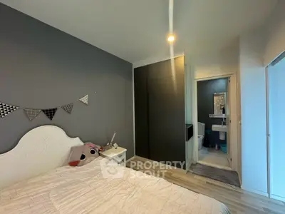 Cozy bedroom with modern decor and en-suite bathroom in stylish apartment