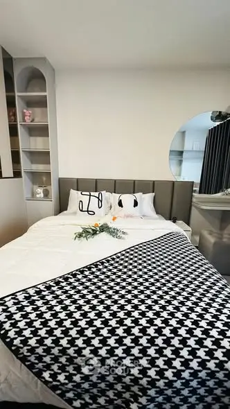 Modern bedroom with stylish decor and cozy bedding in a contemporary apartment.