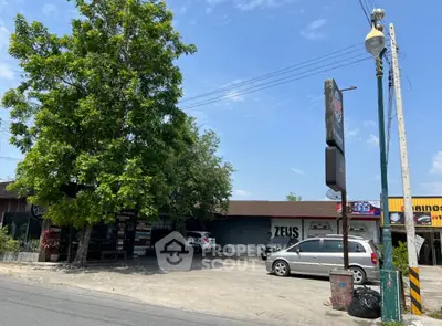 Commercial property with parking space and signage on a sunny day.