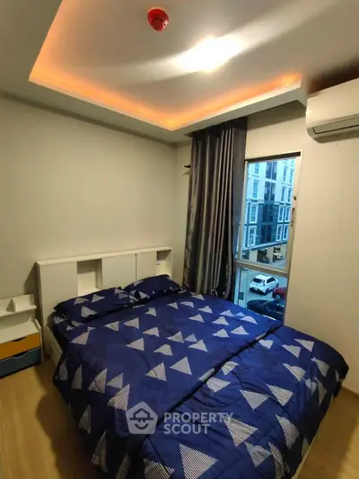 Modern bedroom with stylish lighting and city view from window