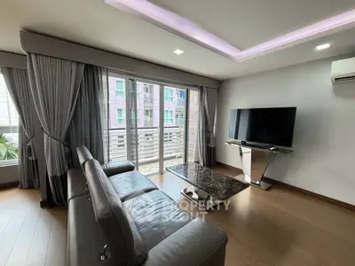 Spacious modern living room with sleek furniture and large windows for natural light.