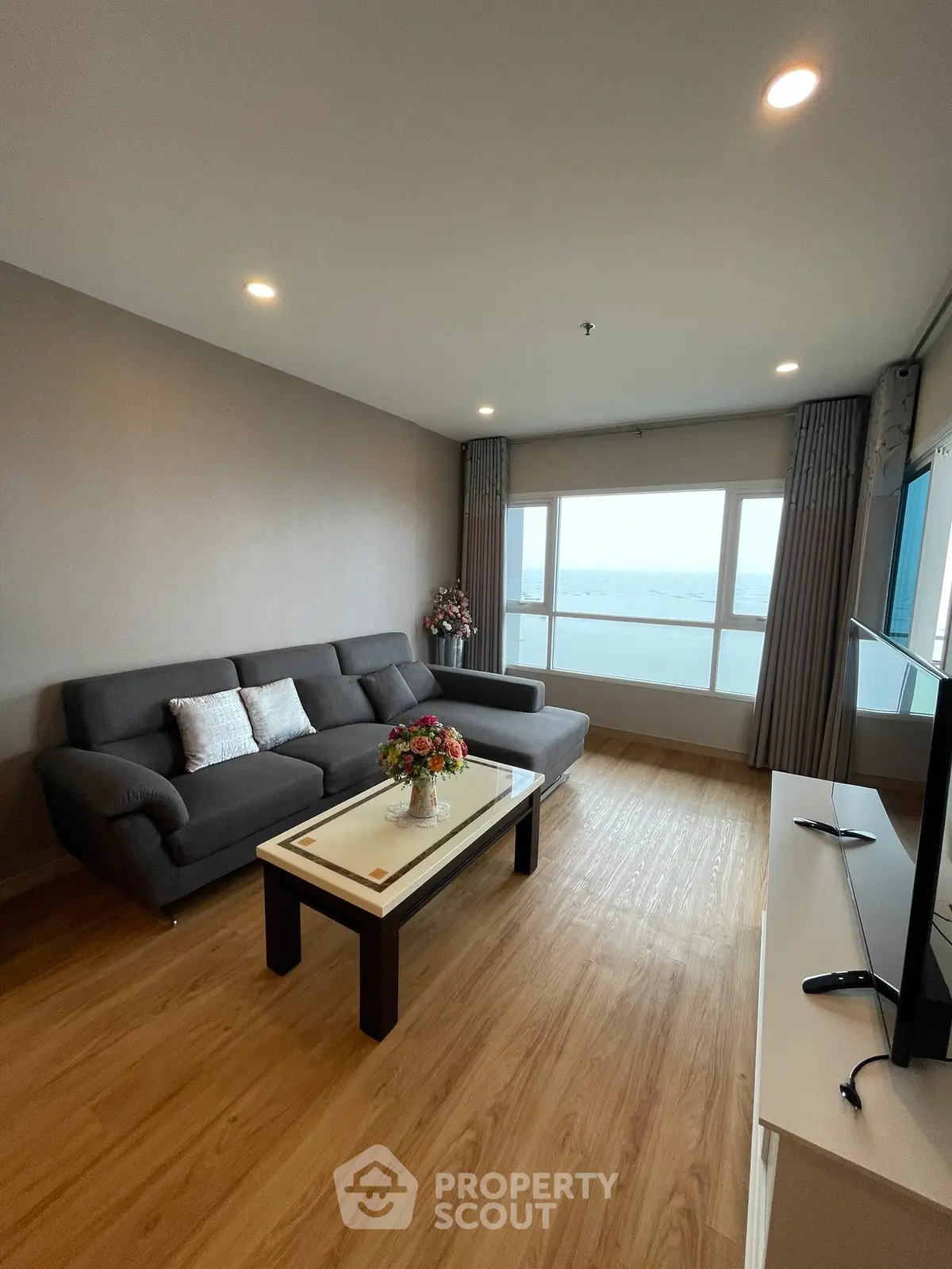 Spacious living room with ocean view, modern sofa, and elegant decor