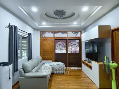 Spacious living room with modern decor and elegant ceiling design