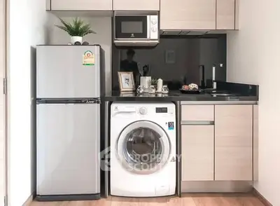 Modern kitchen with sleek appliances and compact design