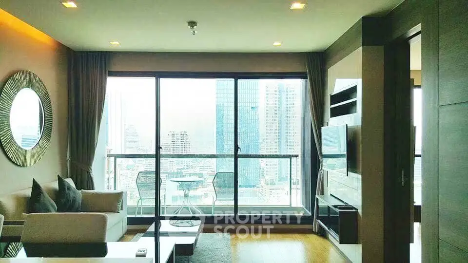 Modern living room with large windows offering stunning city views and stylish decor.