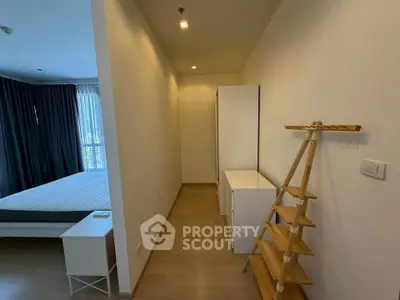 Spacious bedroom with modern minimalist design and ample natural light.
