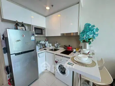 Modern compact kitchen with washing machine and sleek appliances