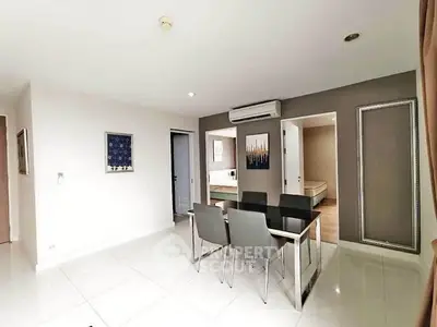 Modern dining area with sleek furniture and open layout in a contemporary apartment.