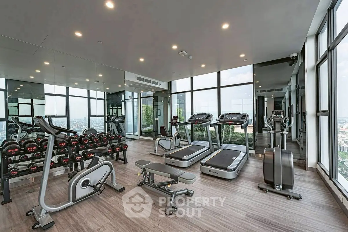 Luxurious high-rise gym with panoramic city views and modern equipment.