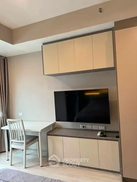 Modern living room with built-in TV unit and study desk, perfect for urban living.