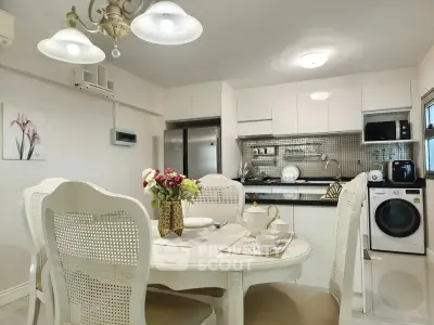 Charming kitchen with dining area, featuring modern appliances and elegant decor, perfect for cozy family meals.