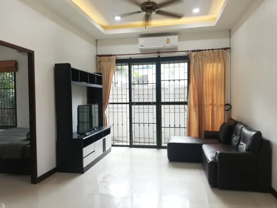 Spacious living room with modern furniture and large windows for natural light.