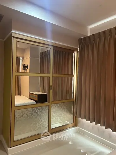Modern bedroom with sliding closet doors and elegant curtains