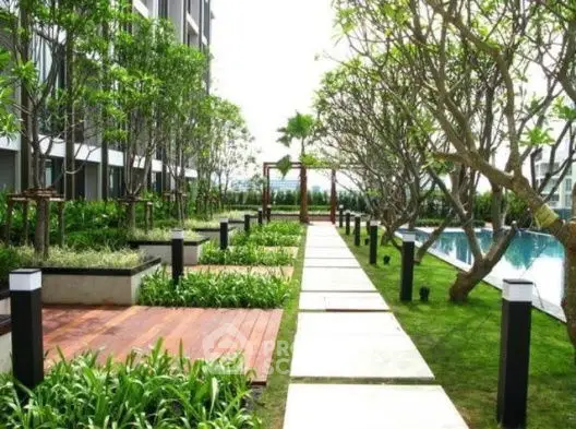 Luxurious garden pathway with poolside view in modern apartment complex