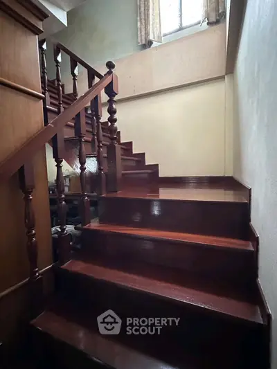 Charming wooden staircase with elegant railing in cozy home interior