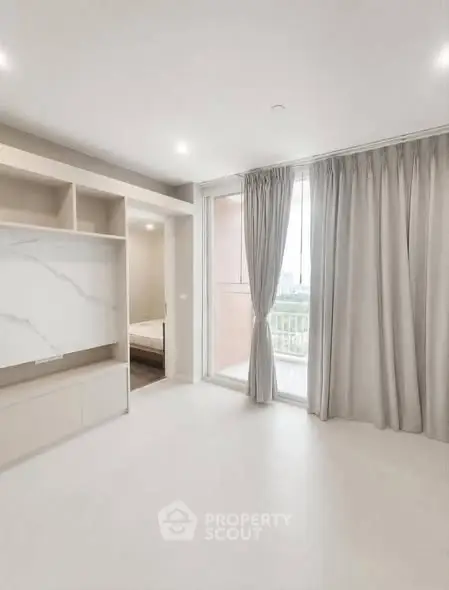 Spacious modern living room with large windows and elegant curtains, offering a bright and airy atmosphere.