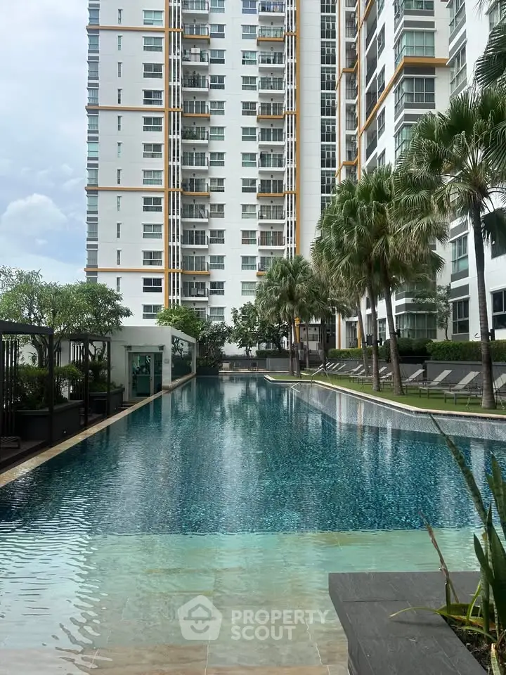 Luxurious high-rise apartment with stunning pool and lush greenery, perfect for modern living.