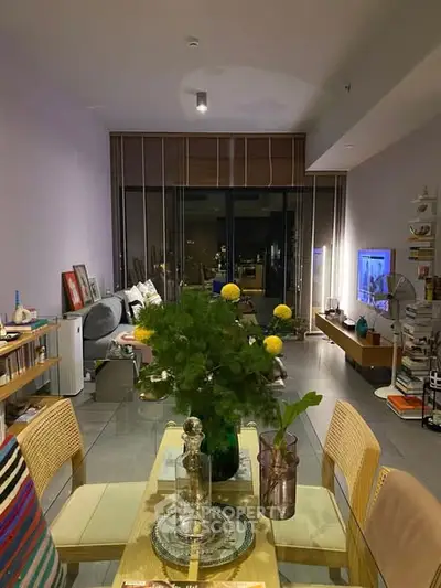 Stylish living room with modern decor and glass dining table, perfect for urban living.