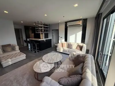 Spacious modern living room with elegant furniture and open kitchen layout