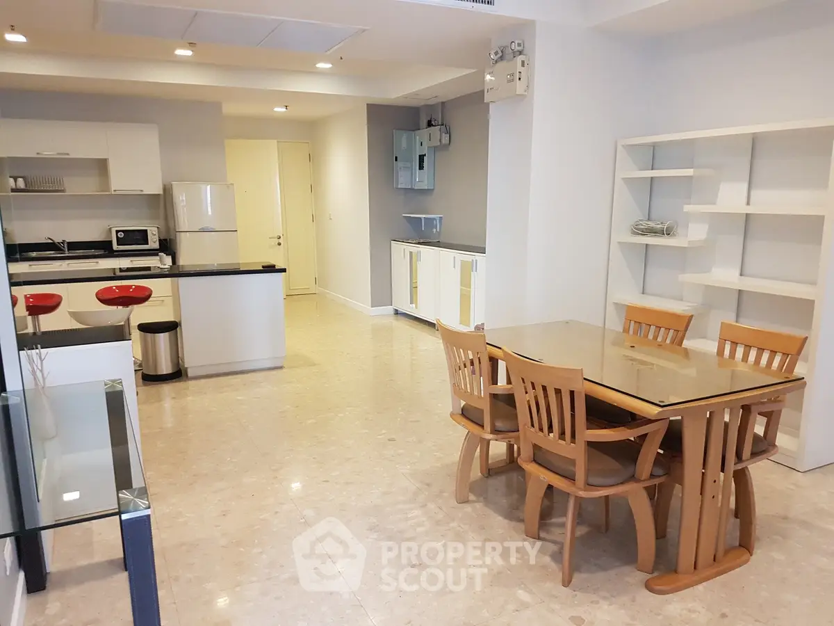 Spacious modern kitchen and dining area with sleek design and ample natural light.