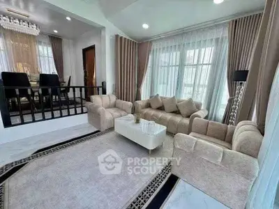 Elegant living room with plush beige sofas and modern decor in a luxurious home.