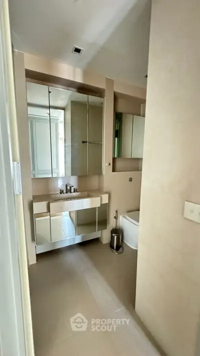 Modern bathroom with sleek design and mirrored cabinets