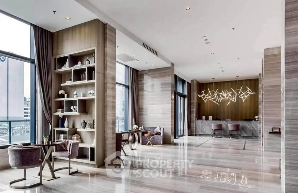 Luxurious modern lobby with elegant decor and floor-to-ceiling windows in upscale building.