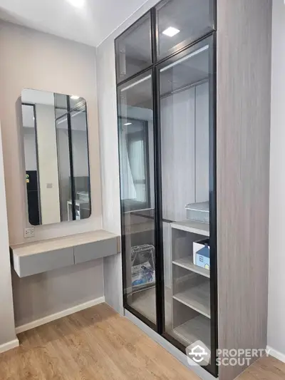 Modern bedroom with sleek mirrored wardrobe and stylish vanity unit