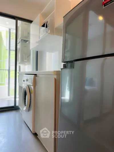 Modern kitchen with sleek appliances and ample natural light