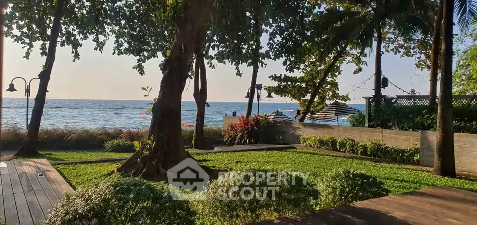 Stunning beachfront garden with lush greenery and ocean view, perfect for relaxation and leisure.