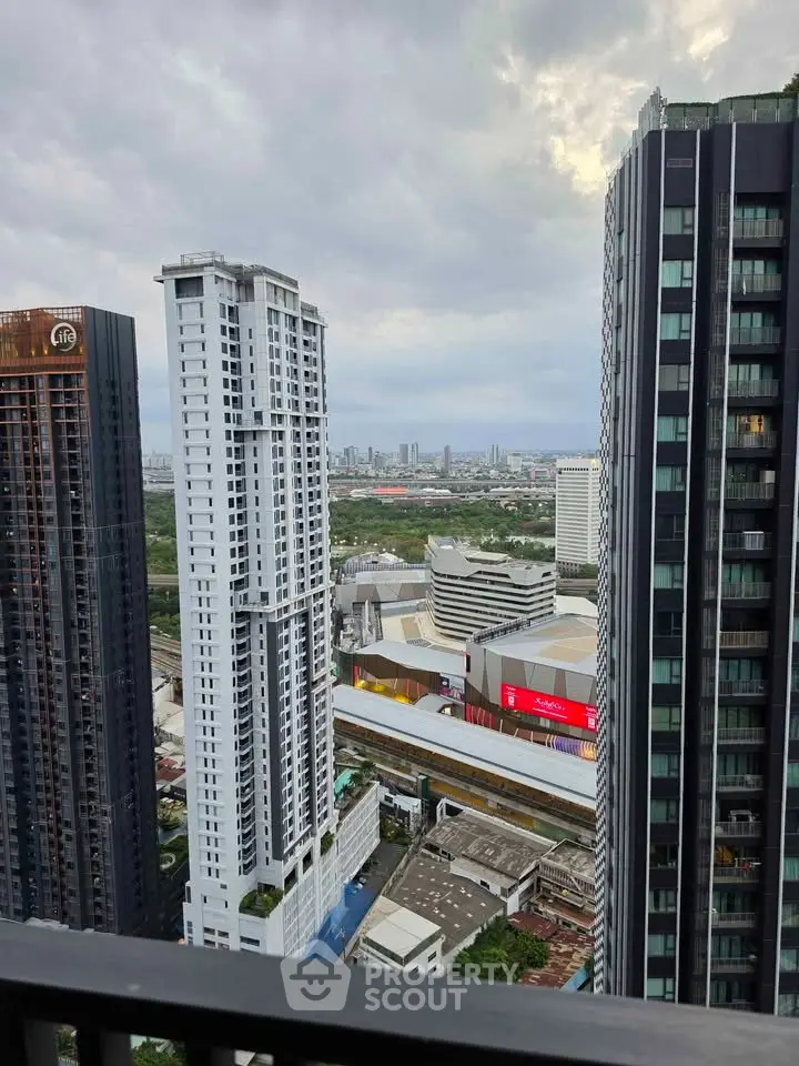 Stunning cityscape view from high-rise balcony showcasing modern skyscrapers and urban skyline.