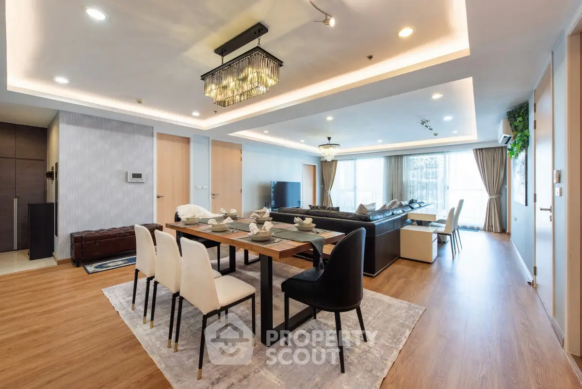Luxurious open-plan living and dining area with elegant decor and modern lighting.