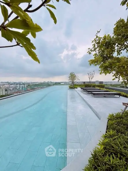 Luxurious rooftop infinity pool with stunning city views and lush greenery.