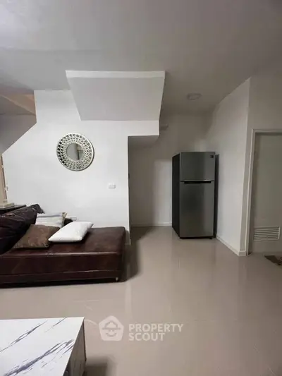Modern living room with sleek fridge and stylish decor