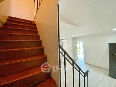 Modern interior with wooden staircase and bright living area