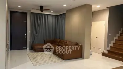 Stylish modern living room with brown leather sofa and elegant decor