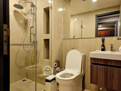 Modern bathroom with glass shower and sleek fixtures in a contemporary home.