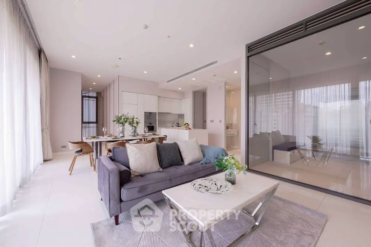 Luxurious open-plan living room with modern kitchen and elegant decor