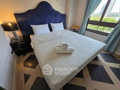 Elegant bedroom with modern decor and city view, featuring a cozy bed and stylish furnishings.