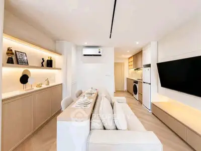 Modern open-plan living room with sleek furniture and integrated kitchen appliances.