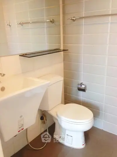 Compact bathroom with modern fixtures and tiled walls, ideal for small spaces.