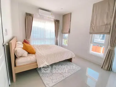 Bright and cozy bedroom with large windows and modern decor
