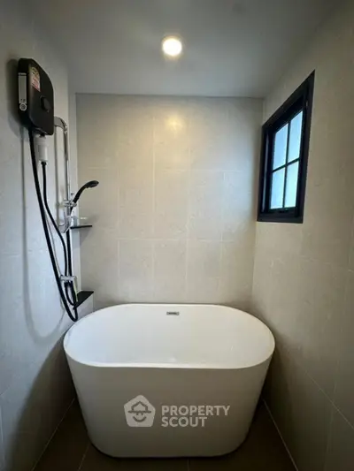 Modern bathroom with elegant bathtub and sleek shower setup