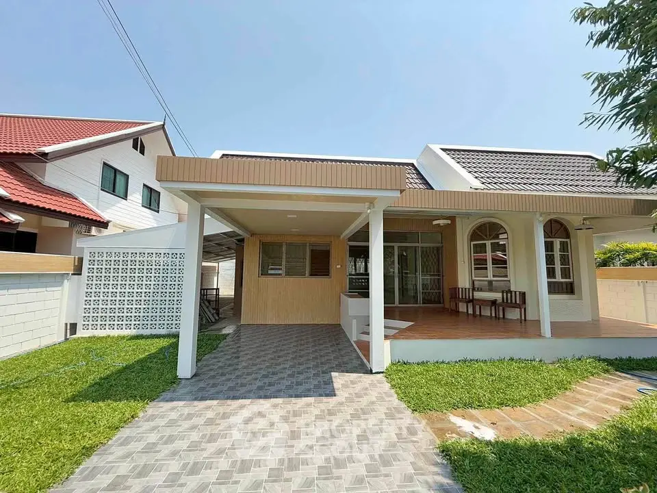 Charming single-story house with covered patio and lush green lawn