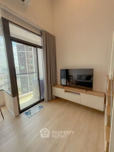 Modern living room with balcony view and sleek TV setup
