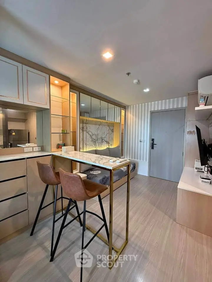 Modern living room with stylish decor and open layout, featuring a cozy seating area and sleek furnishings.