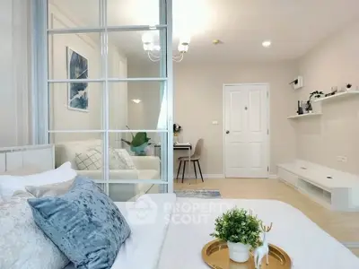 Modern bedroom with elegant decor and cozy living area in open layout apartment.