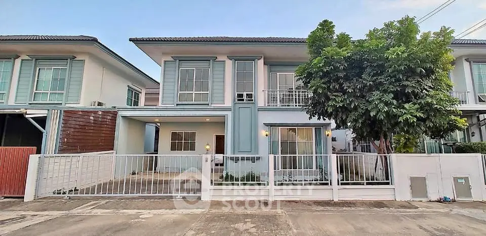 Charming two-story house with modern design and spacious driveway in a serene neighborhood.